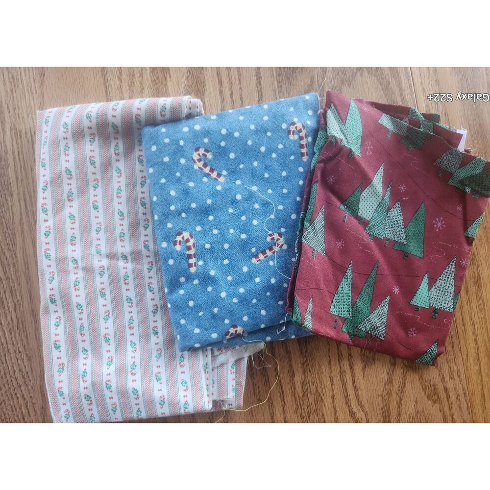 Three blue, red, and green candy cane and evergreen tree fabrics